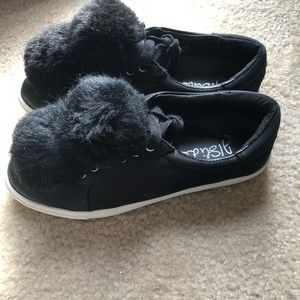 Black sneakers with poms